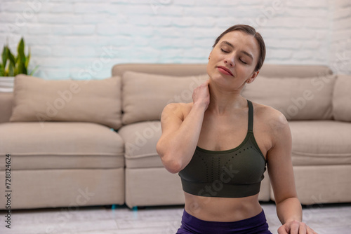 Young woman doing yoga at home and looking relaxed