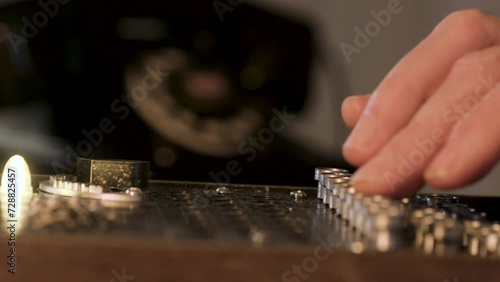 closeup of a man using an WWII enigma code machine