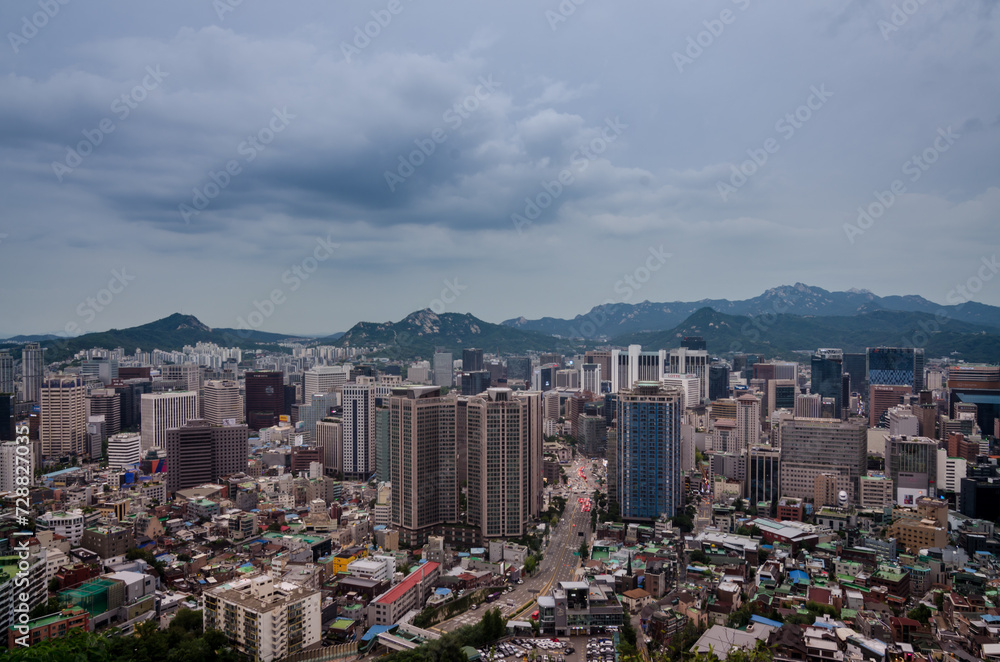 Seoul, South Korea cityscape during a dusk with mountains in a background. Seoul, South Korea cityscape during a dusk with mountains in a background.