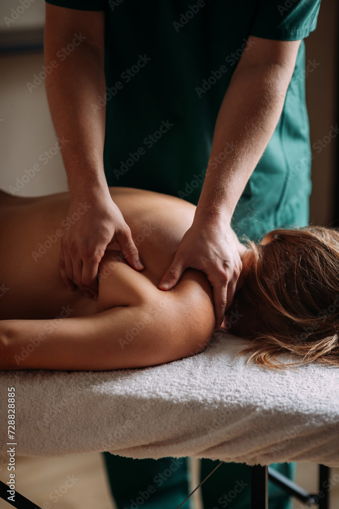 Obraz premium The image shows a womans legs and feet in an indoor setting, possibly during a massage 6060.