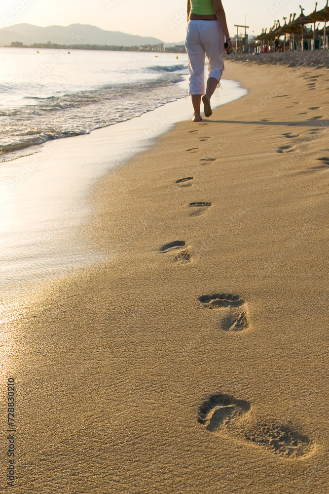 girl walking on the beach leaving footprints in the sand
girl walking on the beach leaving footprints in the sand