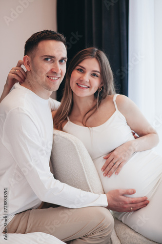 young expectant mother and father at home