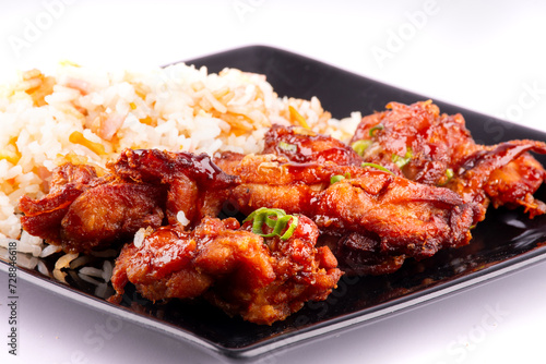 chinese oriental food dish with rice and teriaky fried chicken isolated on white background close up