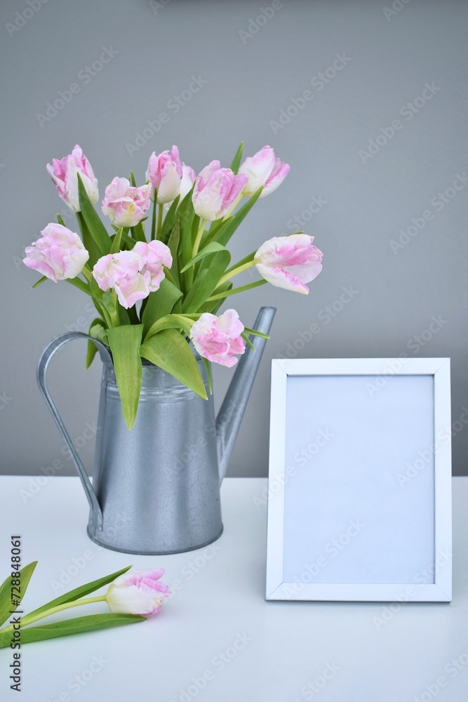 Pink tulips in a metal watering can and frame. Congratulations. Pink tulips in a metal watering can and frame. Congratulations.
