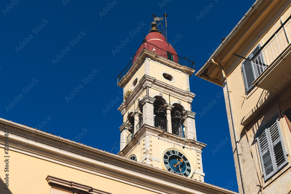 Fototapeta premium Corfu street view, Kerkyra old town beautiful cityscape, Ionian sea Islands, Greece, a summer sunny day, pedestrian streets with shops and cafes, architecture of historic center, travel to Greece
