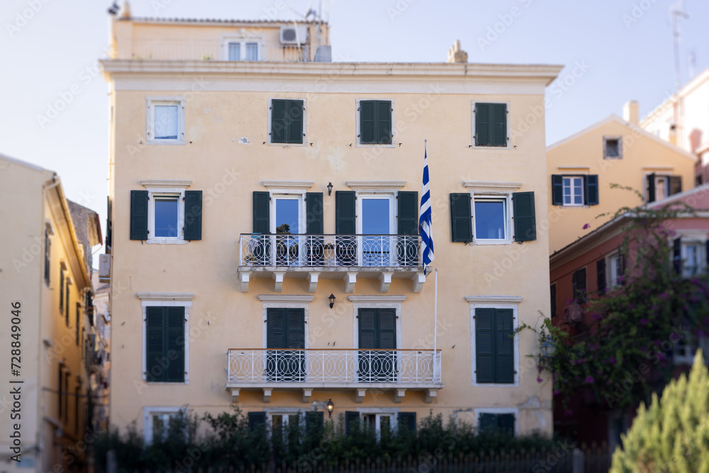 Fototapeta premium Corfu street view, Kerkyra old town beautiful cityscape, Ionian sea Islands, Greece, a summer sunny day, pedestrian streets with shops and cafes, architecture of historic center, travel to Greece