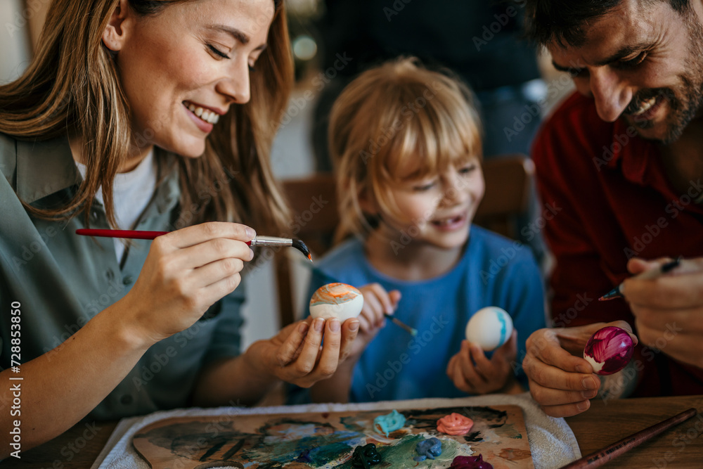 Mom, dad, and daughter create colorful masterpieces in their dining room Mom, dad, and daughter create colorful masterpieces in their dining room