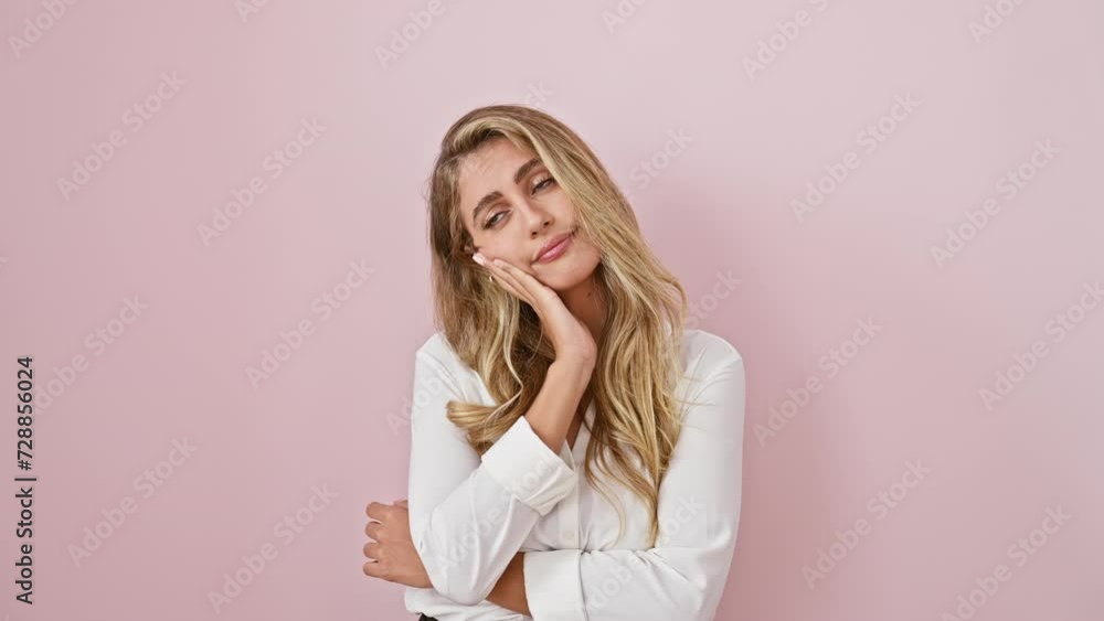 Tired and bored, young blonde woman wearing shirt, thinking of her depression problems with crossed arms. she's standing and looking worn out, isolated over pink background. Tired and bored, young blonde woman wearing shirt, thinking of her depression problems with crossed arms. she's standing and looking worn out, isolated over pink background.
