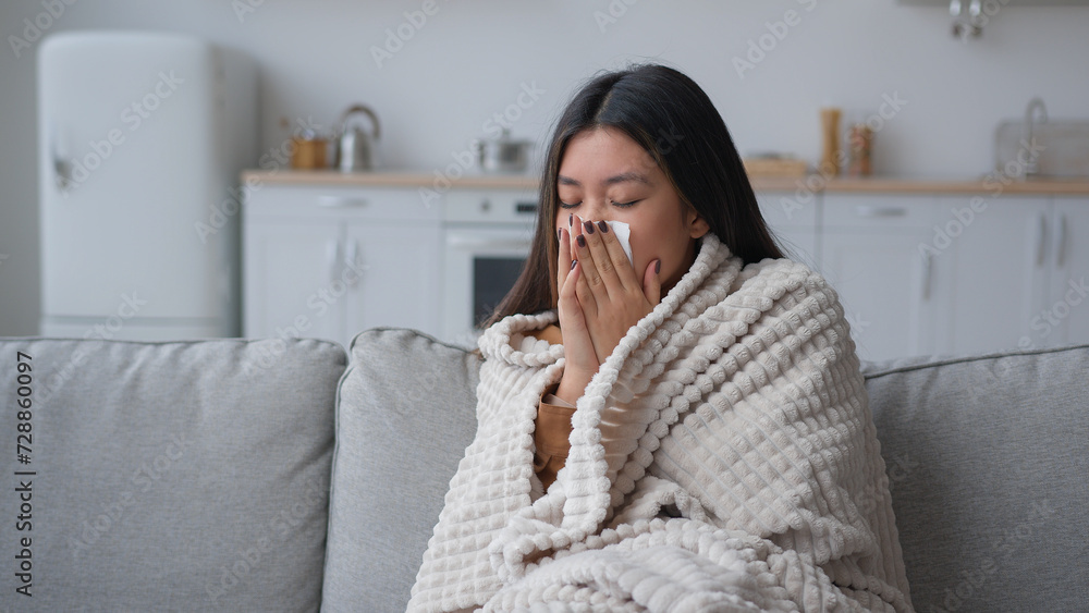 Sick Asian woman covered in blanket sneezing in paper napkin sneeze runny nose feel frozen cold unhealthy korean girl patient has covid symptom grippe nasal infectious disease health treatment at home Sick Asian woman covered in blanket sneezing in paper napkin sneeze runny nose feel frozen cold unhealthy korean girl patient has covid symptom grippe nasal infectious disease health treatment at home