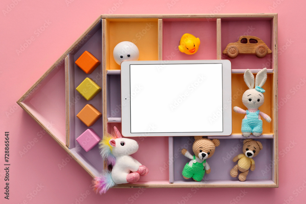 Fototapeta premium Modern tablet and kid's toys on pink background, flat lay. Space for text