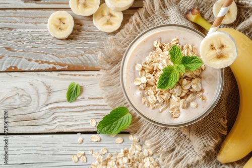 Smoothie with oats and banana on wooden table room for text