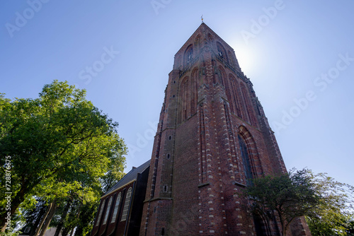 The Kerk van Ransdorp (Church) and Ransdorpertoren (Tower) under blue clear in summer, Ransdorp is a village in part of the municipality of Amsterdam North, The province of Noord Holland, Netherlands. photo