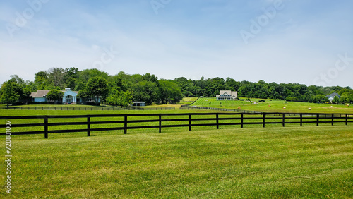 Farmer's house on a mown field under the clouds. Summer village landscape.