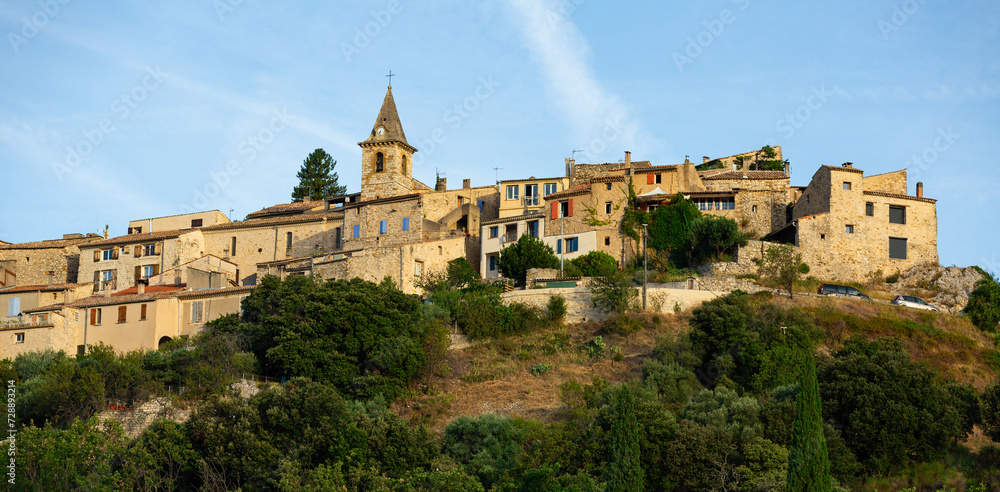 Panoramic view of old constructions surrounded with greenery in Montfort commune, France