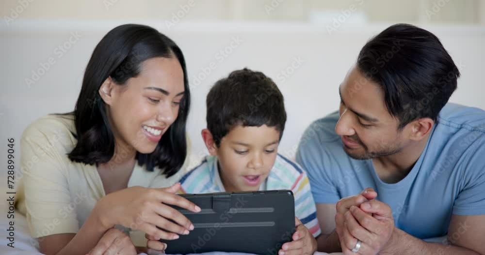 Tablet, laughing and kid with parents on bed watching video, movie or show on the internet. Happy, bonding and boy child with mother and father streaming film on digital technology in bedroom at home Tablet, laughing and kid with parents on bed watching video, movie or show on the internet. Happy, bonding and boy child with mother and father streaming film on digital technology in bedroom at home