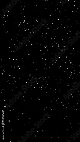 Slow snow twirling falling overlay, falling snowflakes isolated on a black transparent background, 4K vertical video 