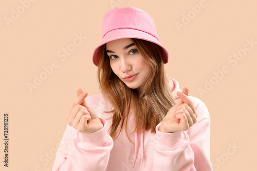 Young woman making heart wi...