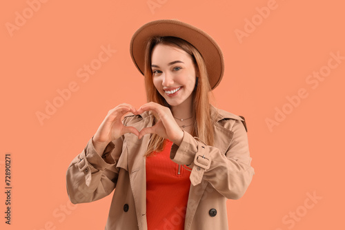 Young woman making heart wi...