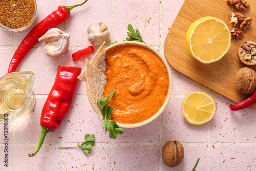 Wallpaper Mural Bowl of tasty muhammara and ingredients on pink tile background Torontodigital.ca