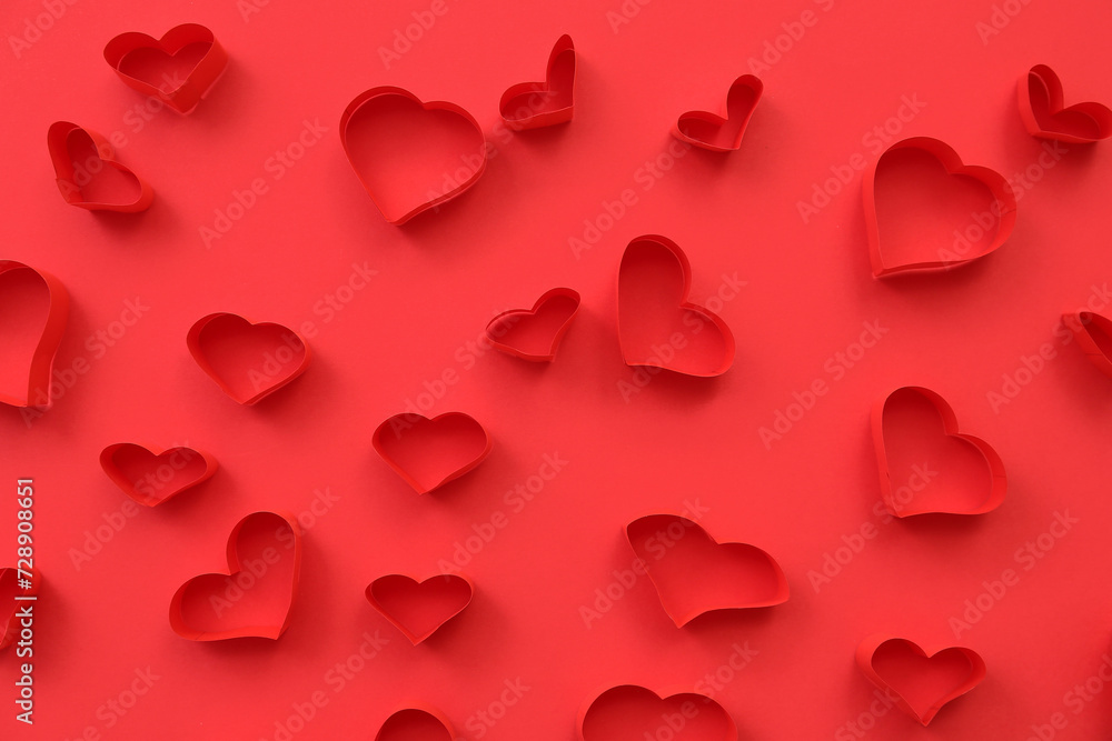 Abstract pattern of red paper hearts on color background
