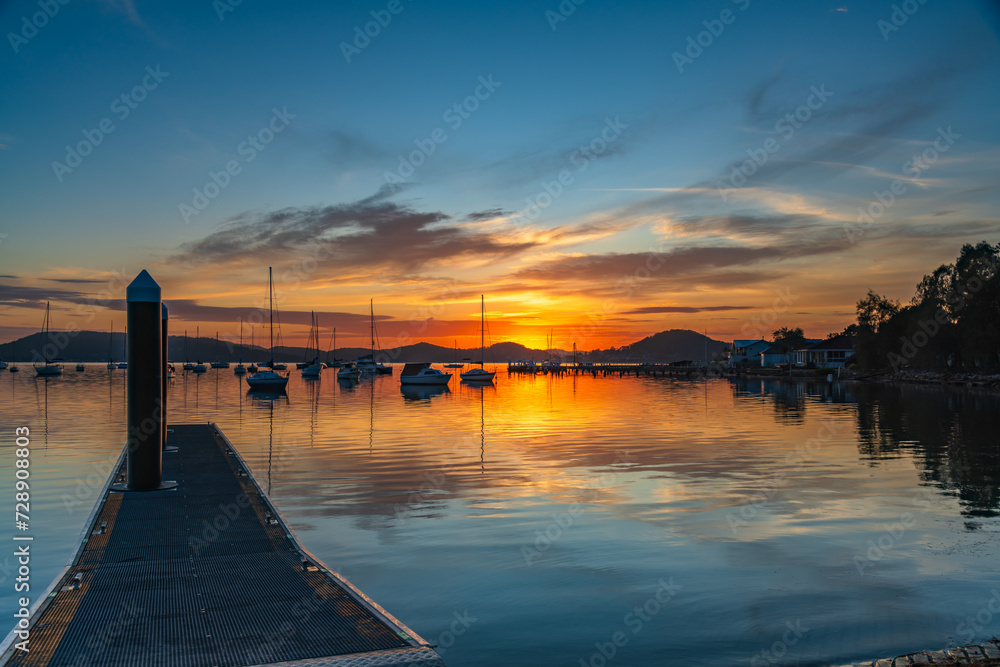 Sunrise, boats and reflections on the water Sunrise, boats and reflections on the water