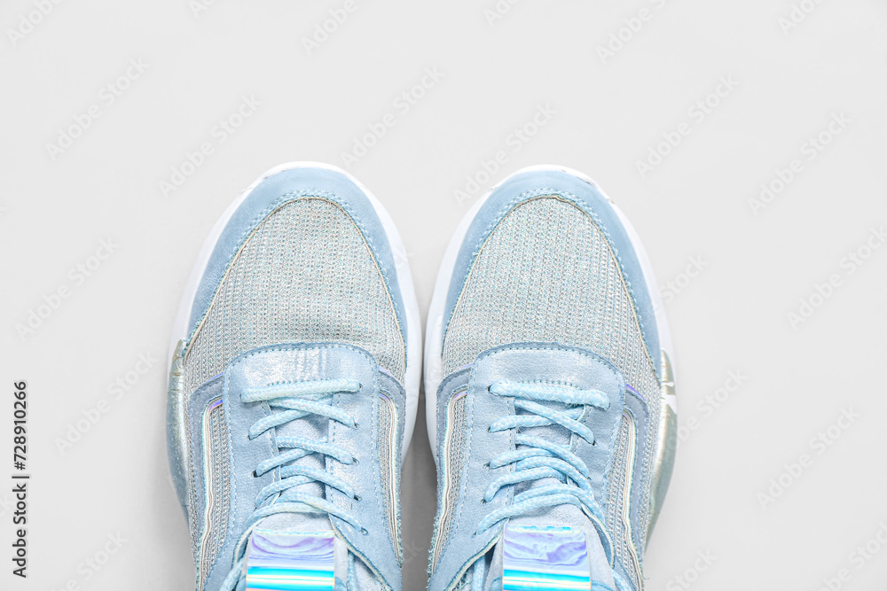Stylish blue sneakers on grey background