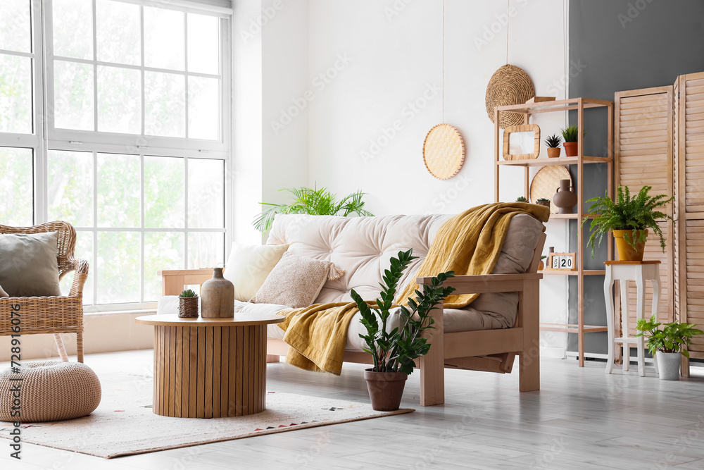 Interior of light living room with cozy white sofa and coffee table ...
