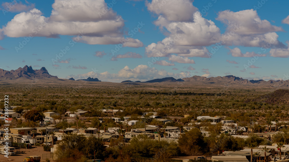 View from above Rv park into the desert and mountains with blue sky