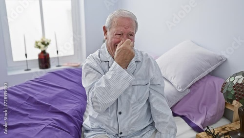 Disgusted senior man in pyjamas encounters reeking stink in bedroom, holding nose to escape intolerable smell photo