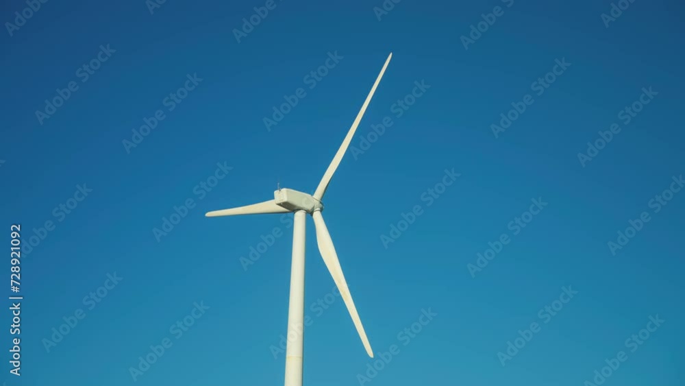 Isolated wind turbine with clear blue sky on the background Isolated wind turbine with clear blue sky on the background