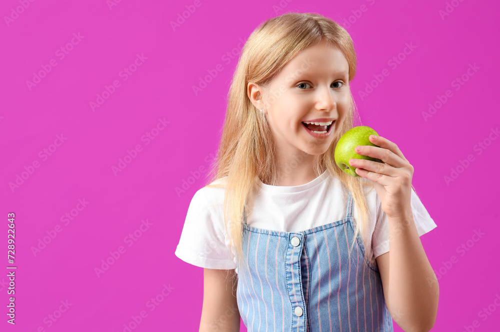 Happy little girl with healthy teeth and fresh apple on purple background Happy little girl with healthy teeth and fresh apple on purple background
