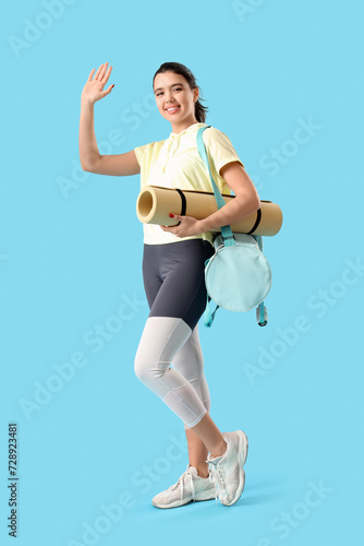 Young woman with fitness ma...
