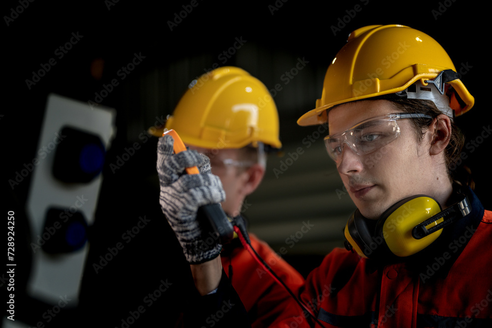 Fototapeta premium male engineer workers maintenance automatic robotic arm machine in a factory. worker checking and repairing automatic robot hand machine. technician worker check for repair factory machine.