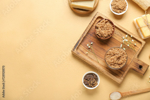 Composition with different body scrubs on color background