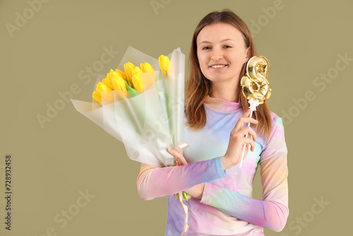 Young woman with bouquet of...