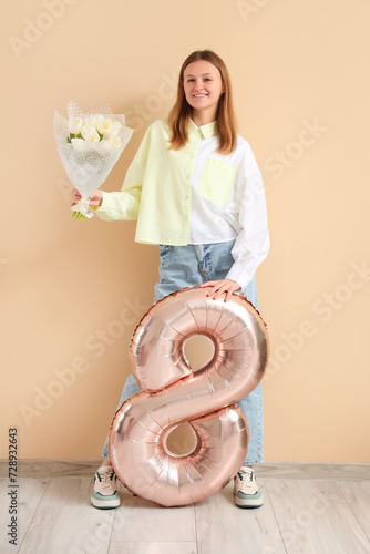 Young woman with bouquet of...