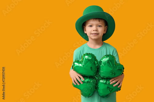 Young boy in green hat hold...