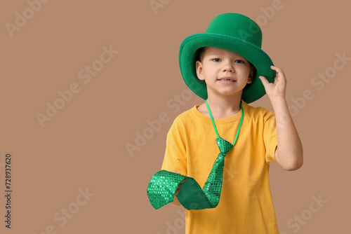 Young boy wearing green hat...