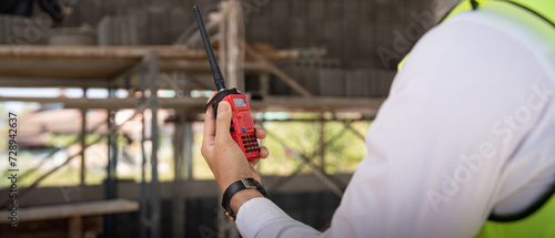 Engineer checking and inspection house project via walkie talkie before delivered to the homeowner. Concept of construction and inspection work