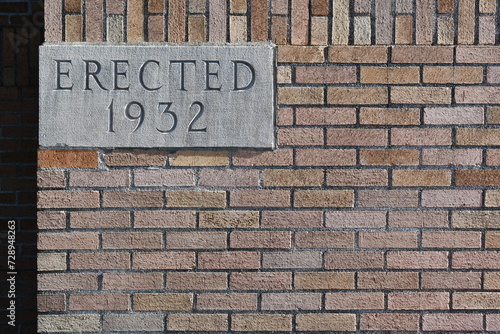 Erected 1932 placard on government building.