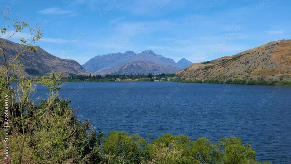Long shot of lake Hayes with mountains behind, New Zealand Long shot of lake Hayes with mountains behind, New Zealand