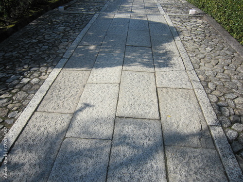 Close up of road pavement made of tiles and cobblestones.