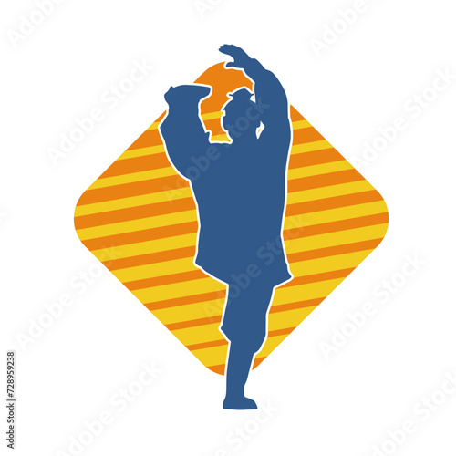 Silhouette of a man in oriental martial art pose. Silhouette of a male in martial art move.