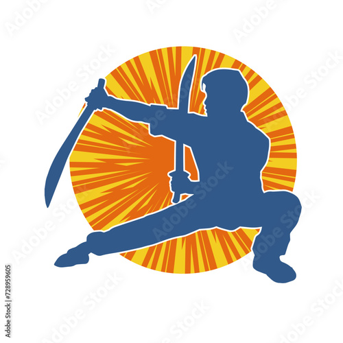 Silhouette of a kungfu or wushu martial art athlete in action pose. Silhouette of a male martial art person in pose with swords weapon.