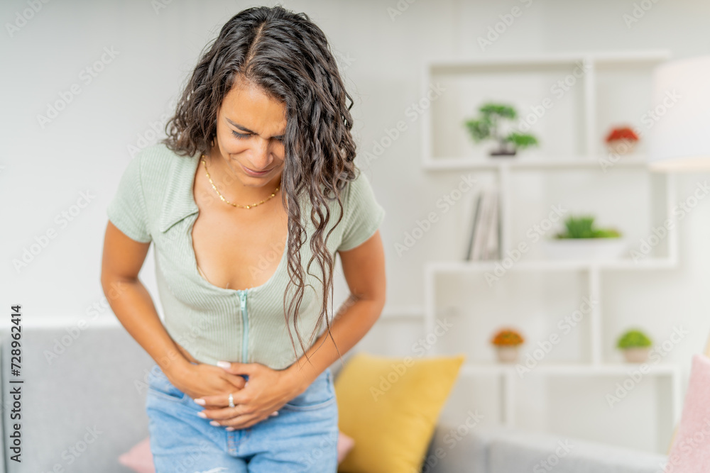 Woman with pain in stomach during menstruation days at home Woman with pain in stomach during menstruation days at home