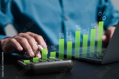 Interest rate and dividend concept, Businessman use laptop analyzing the economic growth graph for investment growth. business financial investment, business growth, income, marketing and profit. photo