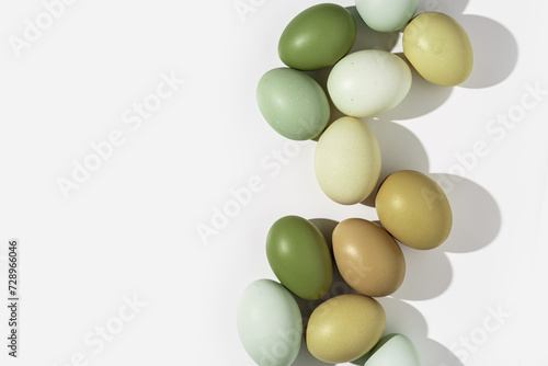 Easter eggs frame background, natural colored eggshell, hard Shadow at sunlight, light white backdrop, copy space. Chicken eggs layout, top view, minimal style flat lay, holiday food still life