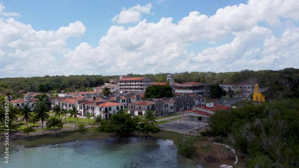 An abandoned colonial town in mexico, surrounded by lush greenery and clear waters, under a cloudy sky, aerial view An abandoned colonial town in mexico, surrounded by lush greenery and clear waters, under a cloudy sky, aerial view