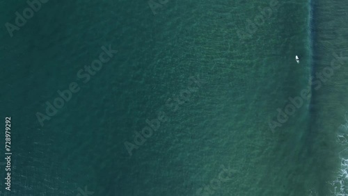 Clear pacific ocean with swimming fish underwater near California. Aerial top down shot. photo