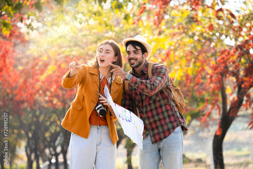 people lifestyle,love,relationship and family concept,cheerful young caucasian couple travel in autumn park,exciting and pointing to something in nature